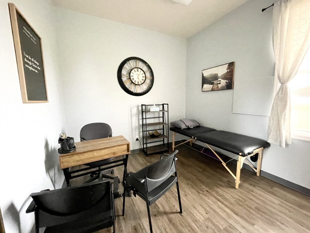 functional medicine consult room with chairs and table at Steadfast Spine and Sport